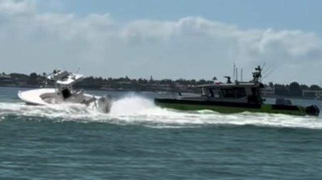 A law-enforcement boat approaches a center console boat that is spinning out of control in Biscayne Bay Saturday, March 28, 2026, off Key Biscayne near the Nixon Beach sandbar. A woman died and a man was seriously hurt after being ejected from the boat.